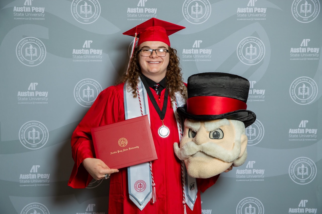 AJ Crowder at Austin Peay graduation with the Gov mascot head.