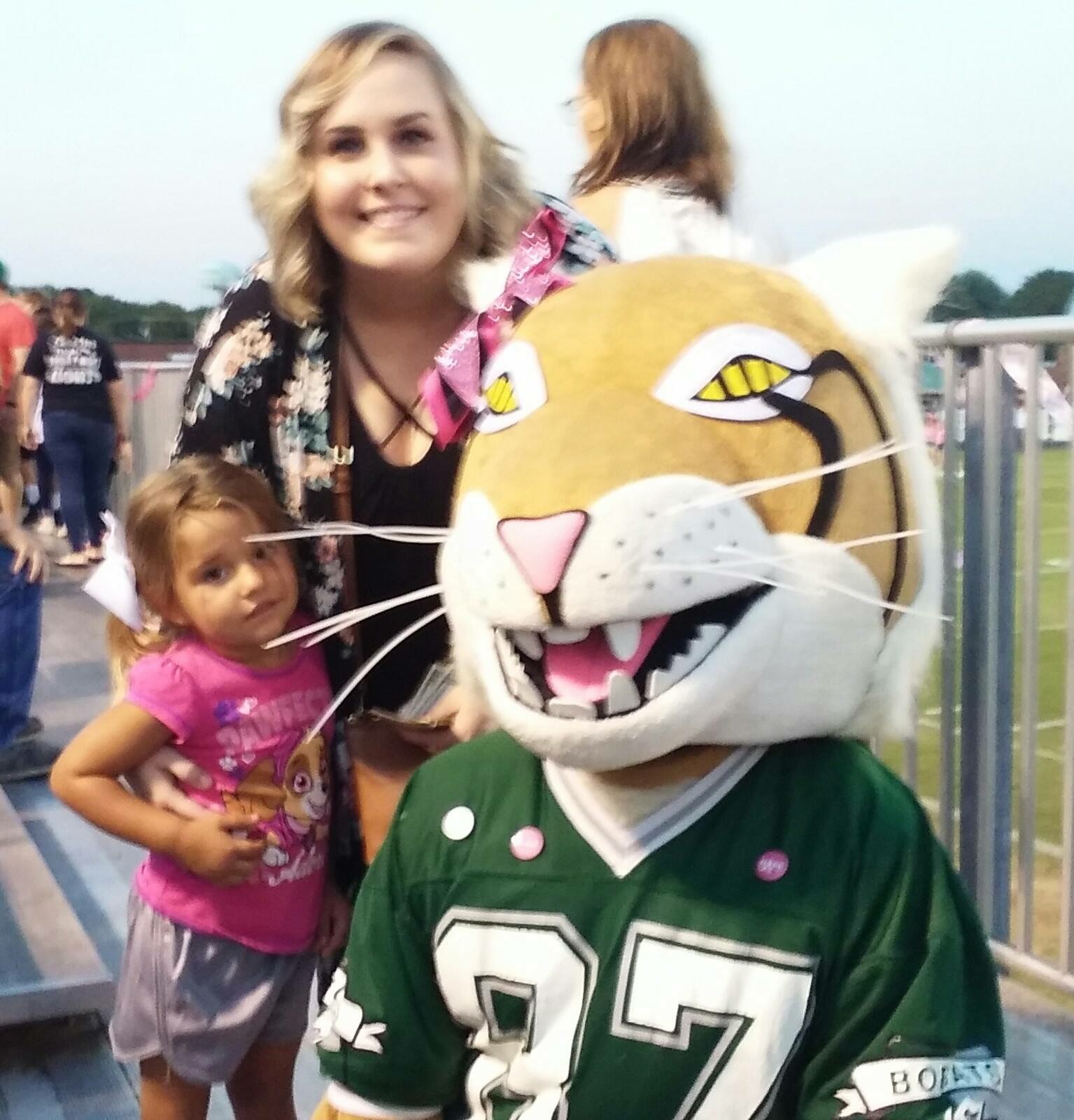 Bobby Bobcat with a teacher and young fan during AJ’s middle-school years.