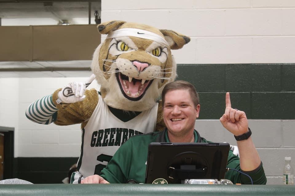 Bobby posing with a member of the game-day crew at the scorer’s table.